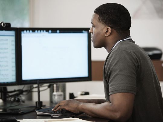 Person using a computer with two monitors