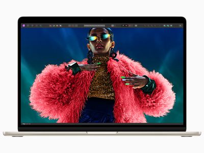 M3 MacBook Air with a Black woman in an amazing pink fluffy jacket on the screen.