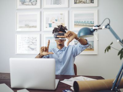 Someone wearing a VR headset while working from a home office.