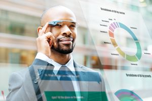 Man wearing smart glasses and looking at augmented reality charts