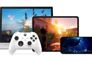 Xbox games on iPad, MacBook, and iPhone next to a while xbox controller