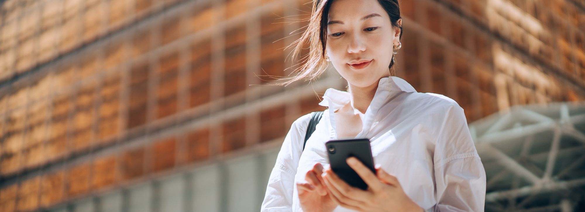 Asian woman using her smartphone.