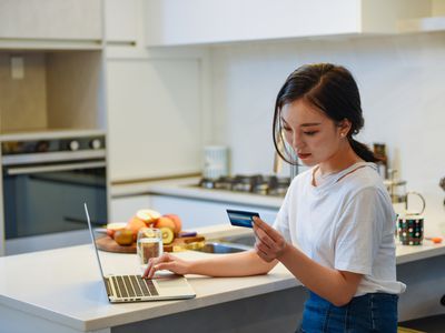 Woman shopping online with credit card.